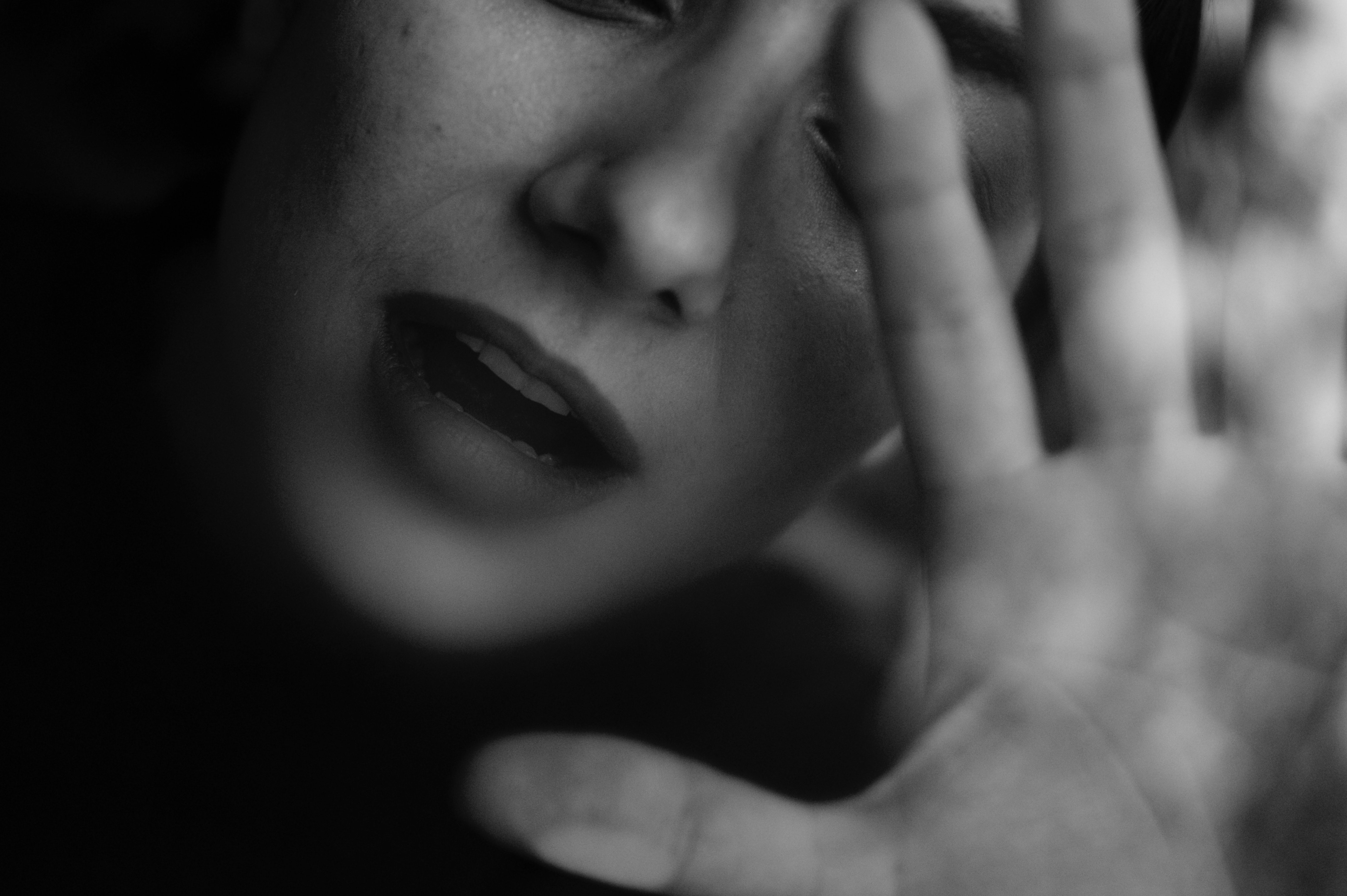 Photo of a woman with her palm in front of her face